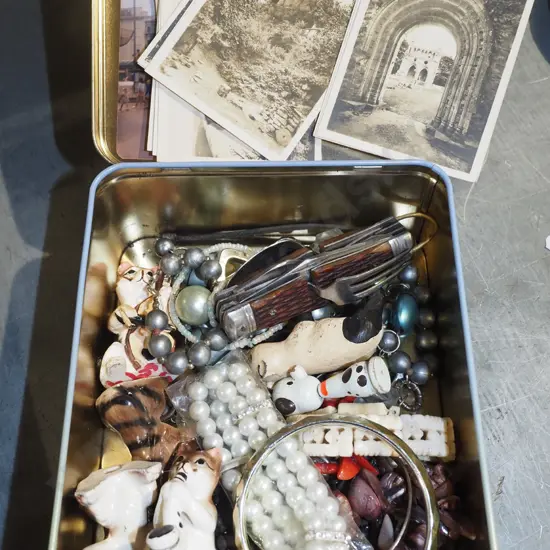 tin of postcards, costume jewellery, figurines etc