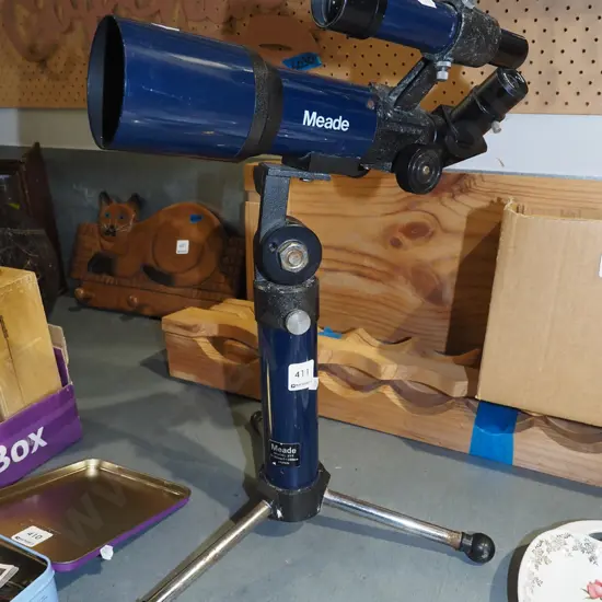 small Meade astronomical telescope on stand