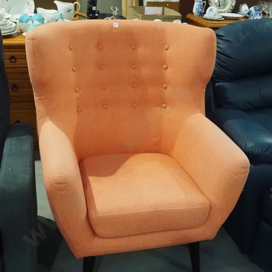 modern orange upholstered wingback armchair - slight fading