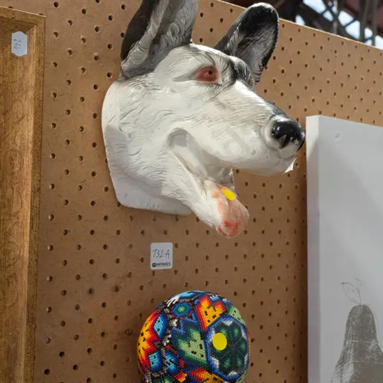 composite dog head wall ornament and colourful beaded skull