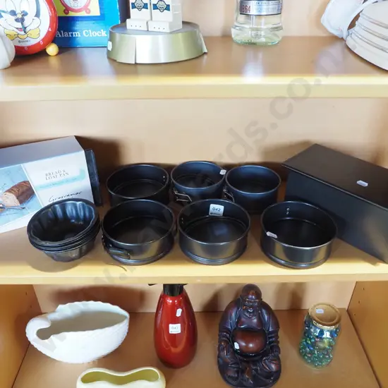 shelf; bread and loaf pans, small cake tins etc
