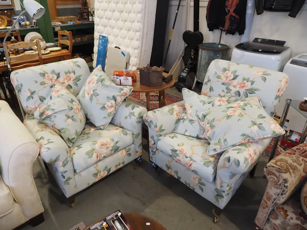 pair of magnolia floral armchairs with cushions and on brass casters Image 1++