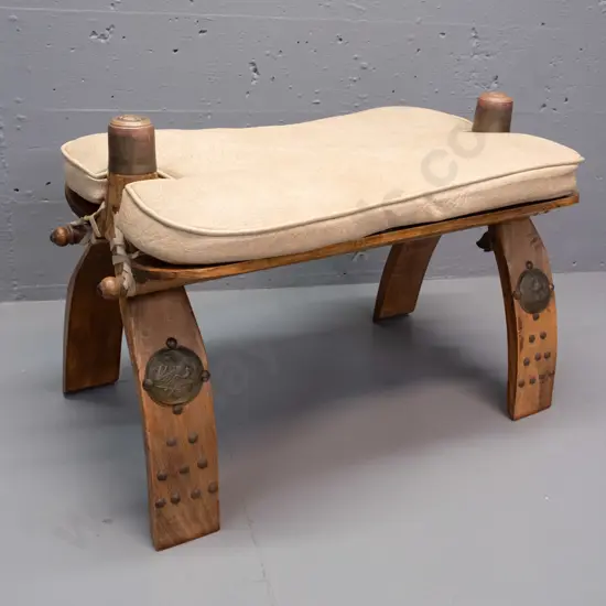 beech camel stool with lift off vinyl squab, Egyptian style applied brass caps and decoration