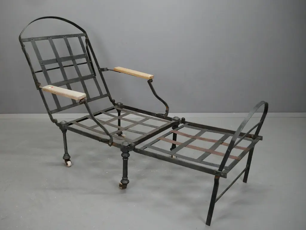 Victorian wrought and cast iron framed chair folding out to narrow bed with beech arms, on white porcelain casters, with Image 1++
