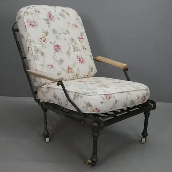 Victorian wrought and cast iron framed chair folding out to narrow bed with beech arms, on white porcelain casters, with