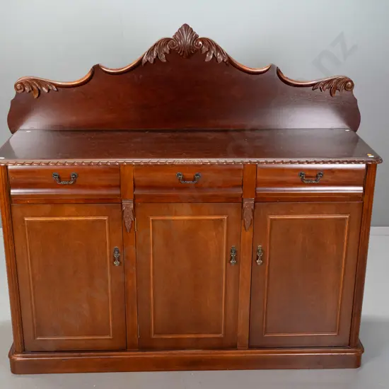 reproduction mahogany Victorian style carved-back sideboard with gadrooned top edge, 3 drawers above 3 panelled cupboard