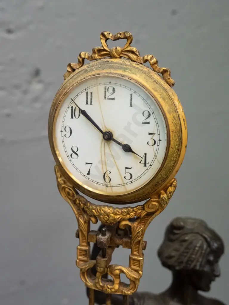 vintage mystery clock with figural cast spelter base, gilt finish over brass on ornate movement - base marked FJH and Image 1++