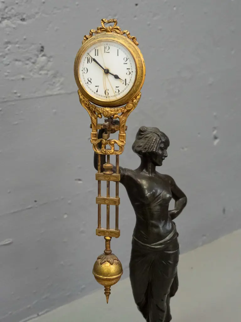 vintage mystery clock with figural cast spelter base, gilt finish over brass on ornate movement - base marked FJH and Image 1++