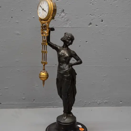 vintage mystery clock with figural cast spelter base, gilt finish over brass on ornate movement - base marked FJH and
