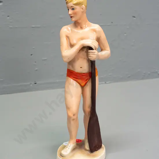 vintage sportsman figure in orange trunks, holding paddle - no maker's marks, stamped 1065 in base H-260
