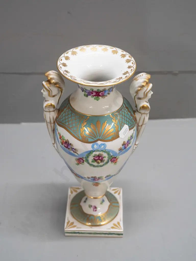 porcelain handled urn vase with figural handles, gilt & floral decoration, on sqaure base, marked "Made In Germany East" Image 1++