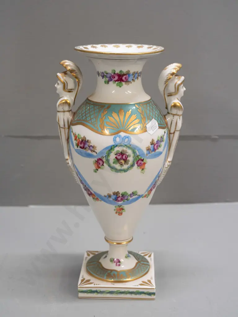 porcelain handled urn vase with figural handles, gilt & floral decoration, on sqaure base, marked "Made In Germany East" Image 1++