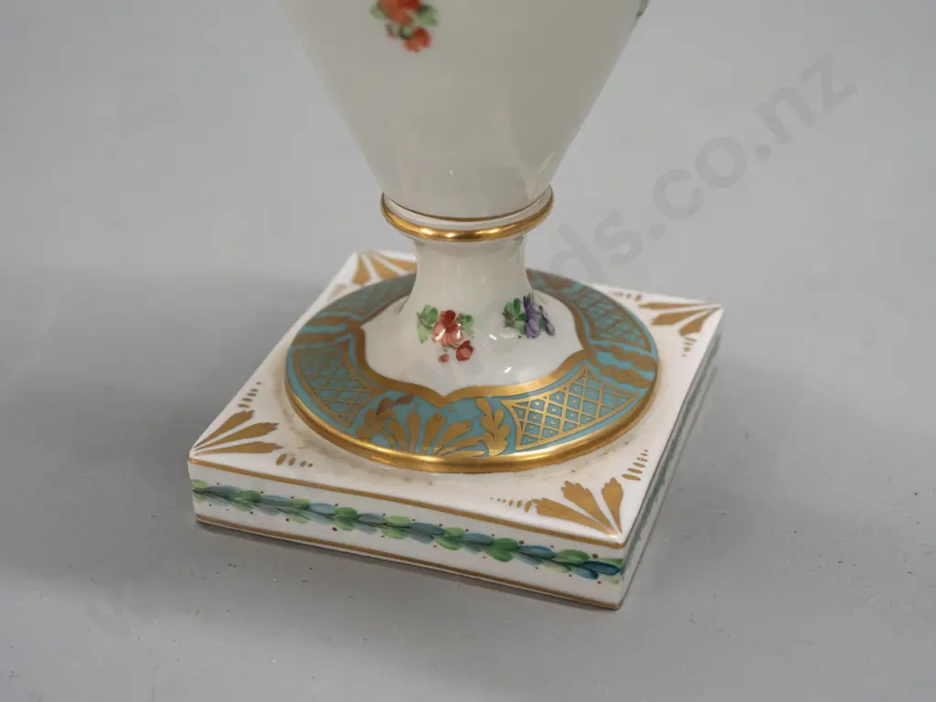 porcelain handled urn vase with figural handles, gilt & floral decoration, on sqaure base, marked "Made In Germany East" Image 1++