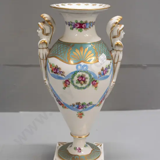 porcelain handled urn vase with figural handles, gilt & floral decoration, on sqaure base, marked "Made In Germany East"