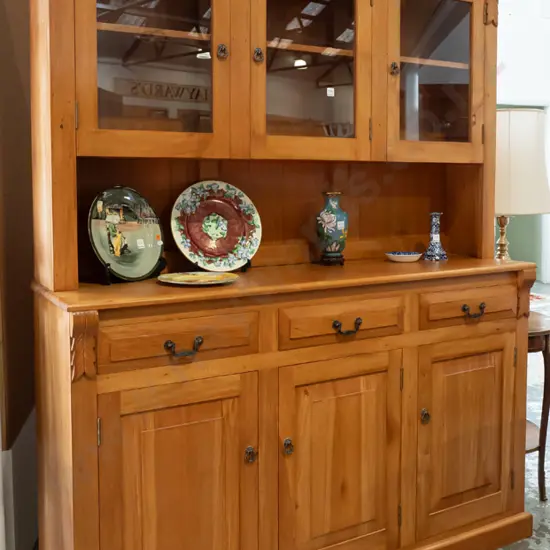 reproduction colonial-style rimu dresser with 3 glazed doors in top, one shelf, above panelled gallery, 3 drawers and 3