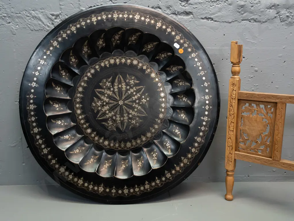 etched metal tole-ware tray on folding pierced and carved timber 4-legged base stamped Made in India. Some wear to black Image 1++
