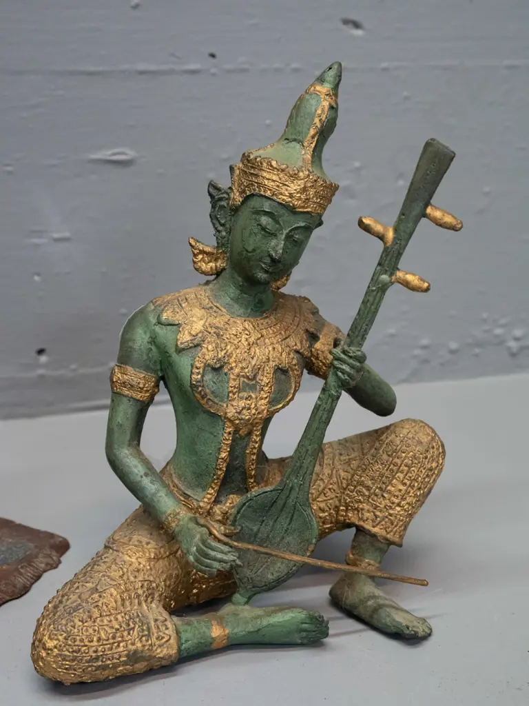 pair of Austrian cast metal book-ends with Arabian scenes and a Thai or Indonesian cast metal seated musician figure - Image 1++