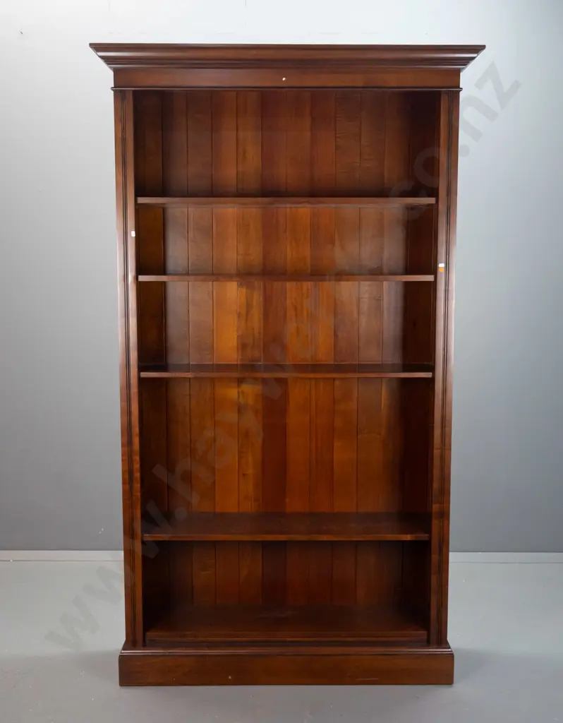 colonial style beech bookcase with reeded sides, 4 adjustable shelves, one fixed, shaped cornice top. Bruise to front of Image 1++