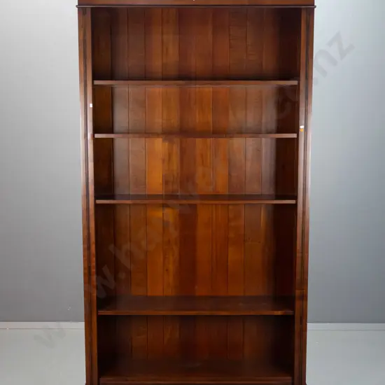 colonial style beech bookcase with reeded sides, 4 adjustable shelves, one fixed, shaped cornice top. Bruise to front of
