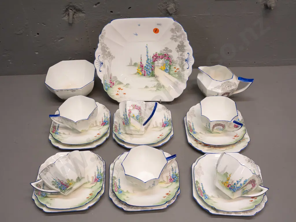 Shelley 21-piece tea set - floral with blue edging - 6 trios, cake plate, cream & sugar. Sugar bowl has staining inside Image 1++