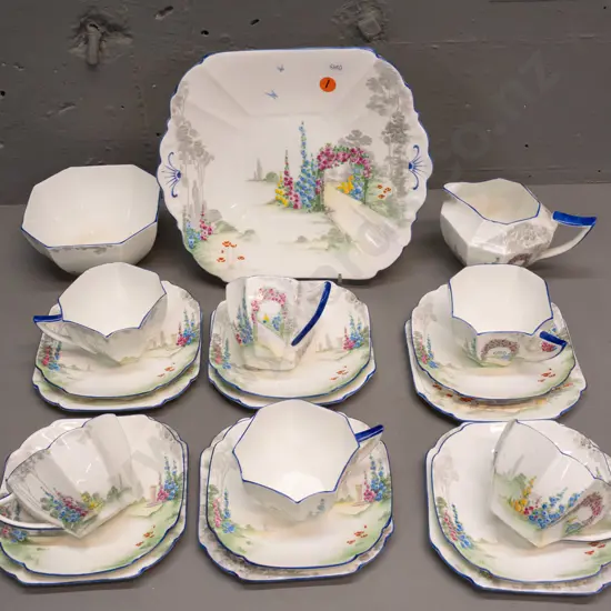 Shelley 21-piece tea set - floral with blue edging - 6 trios, cake plate, cream & sugar. Sugar bowl has staining inside