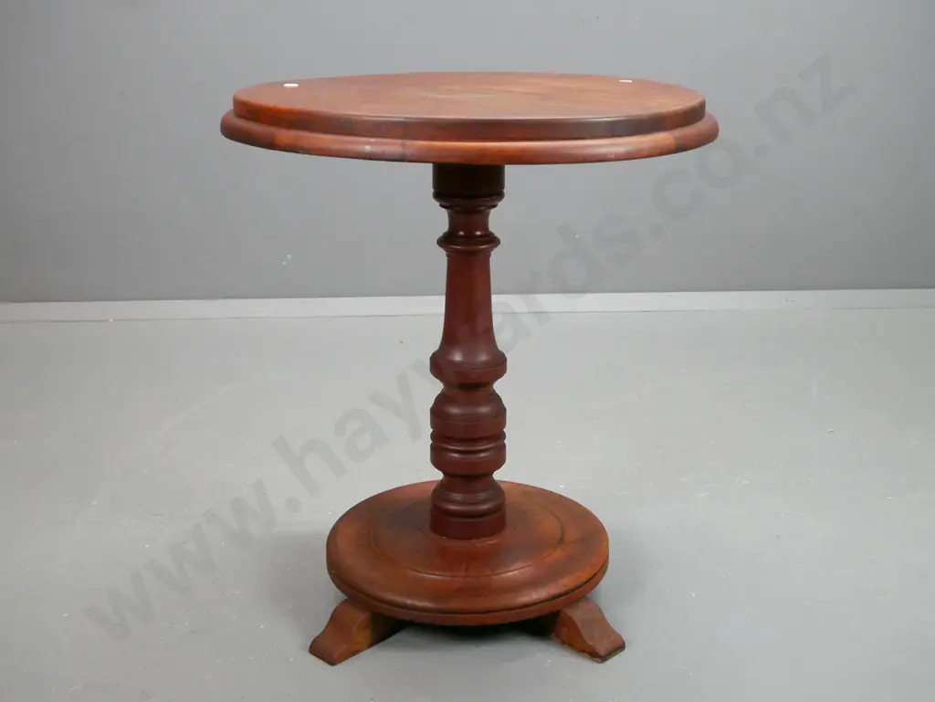 oak and mahogany circular side table with turned column support on base with sweeping legs. Image 1++