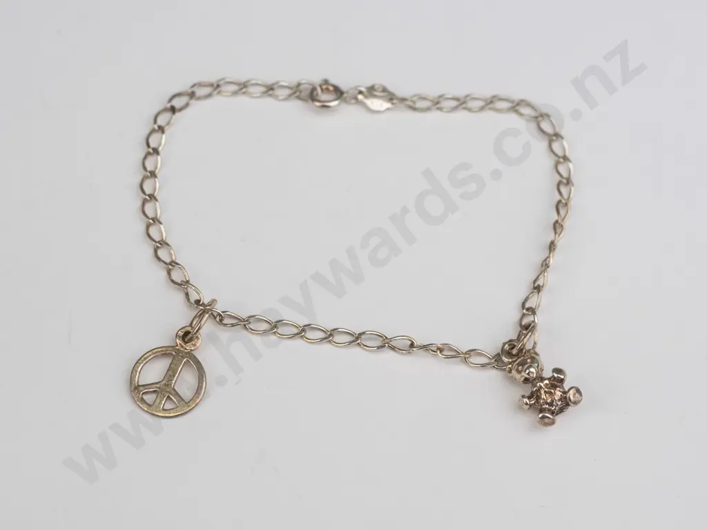 silver charm bracelet stamped 925 with teddy bear & peace sign charm Image 1++