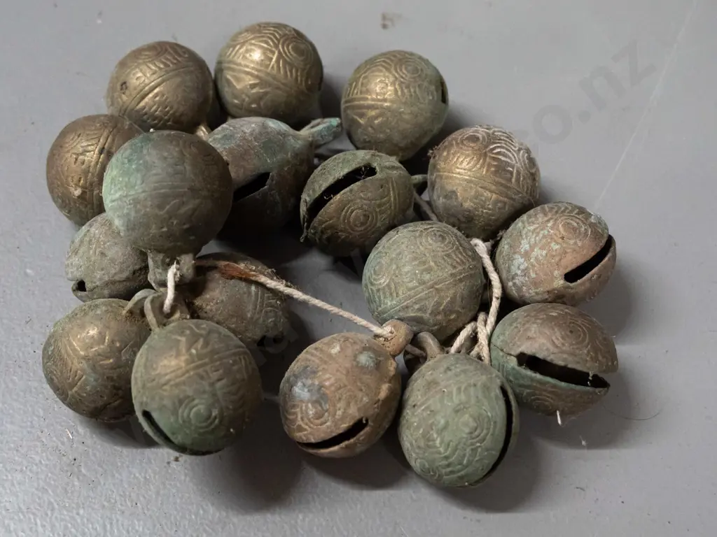 Tibetan cast brass bells with scrolling patterns - each approx. 2.5 cm long Image 1++