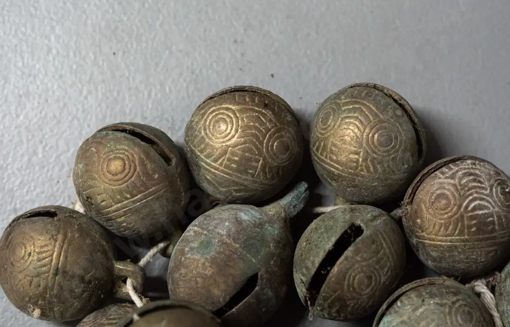 Tibetan cast brass bells with scrolling patterns - each approx. 2.5 cm long Image 1++