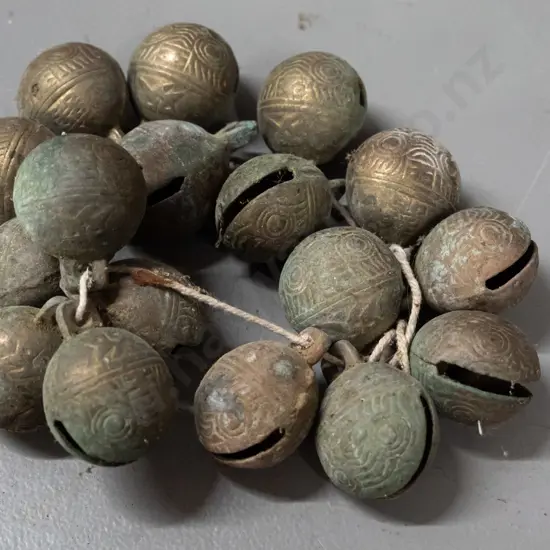 Tibetan cast brass bells with scrolling patterns - each approx. 2.5 cm long