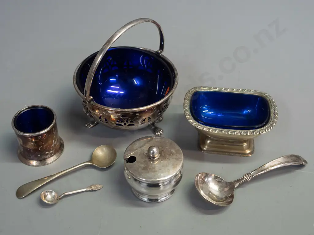 4 silver-plated salts & condiments with blue glass liners - and 3 spoons. Footed basket with handle H-110 L-100 marked Image 1++