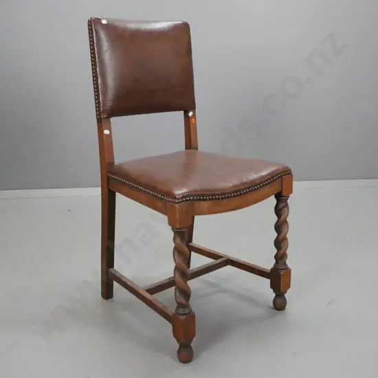 vintage oak side chair with twist front leg supports on stretcher base, brown leather with brass studs.