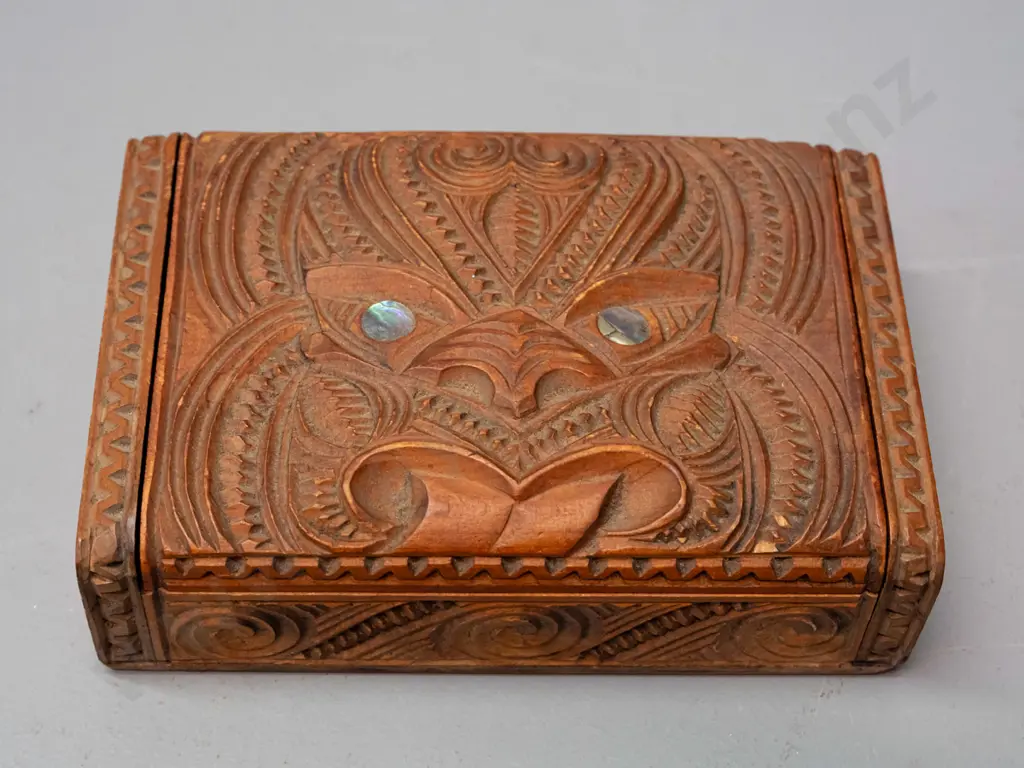 carved native timber trinket box with Maori motif carving, paua inset eyes, hinged lid H-45 W-170 D-110 Image 1++