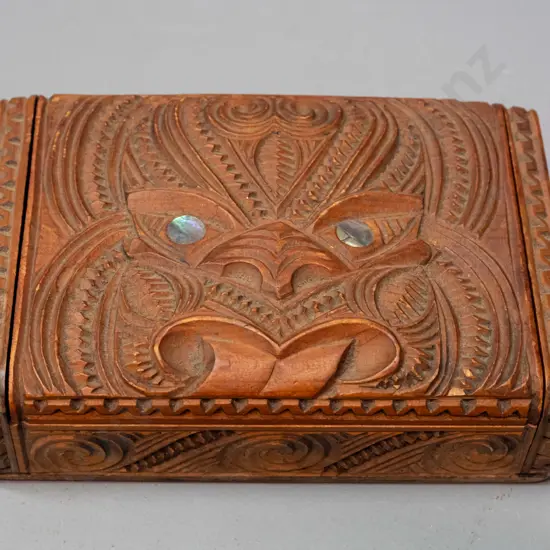 carved native timber trinket box with Maori motif carving, paua inset eyes, hinged lid H-45 W-170 D-110