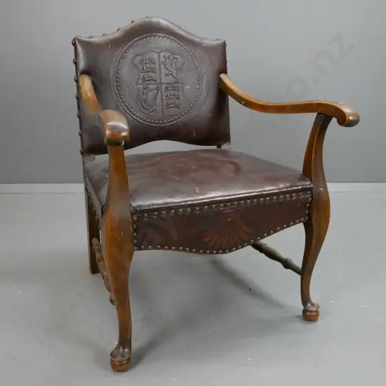 oak fireside chair with sweeping arms on cabriole and ball legs with turned supports. Leather seat