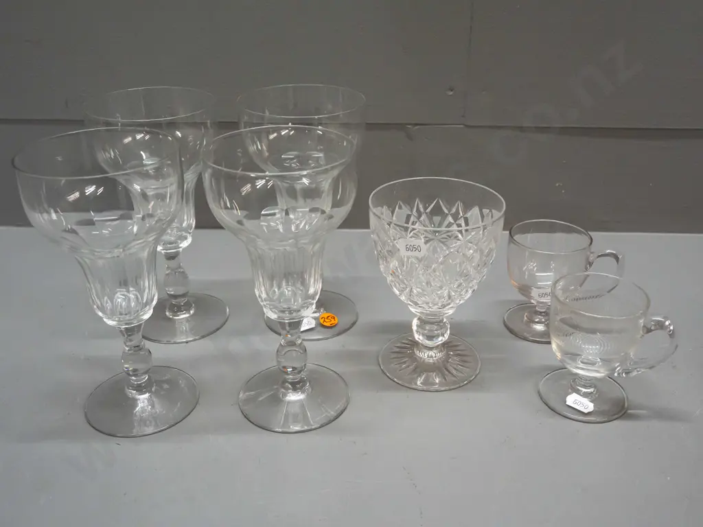 7 glass items - Stuart crystal goblet, 2 small handled & footed liquers, one with etched band, and 4 other stemmed Image 1++