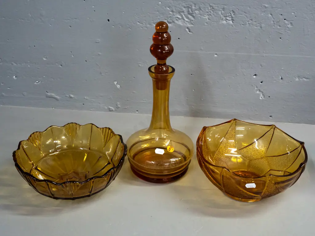 3 pieces of amber glass - stoppered decanter and 2 moulded salad bowls. Decanter has tiny nick in rim, some staining Image 1++