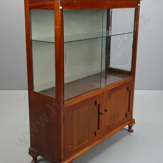 vintage mahogany display case with 2 glass sliding glass doors above 2 wooden panelled doors,