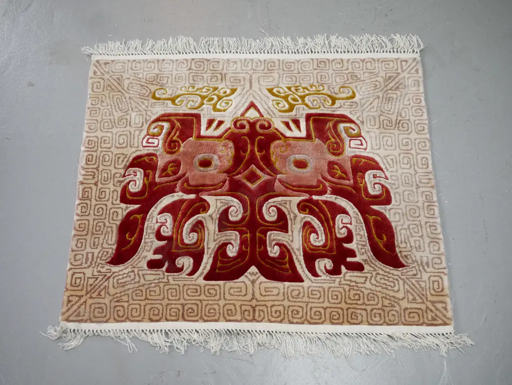 small wool floor mat with abstract Asian or Indonesian mask design 770 x 640 Image 1++