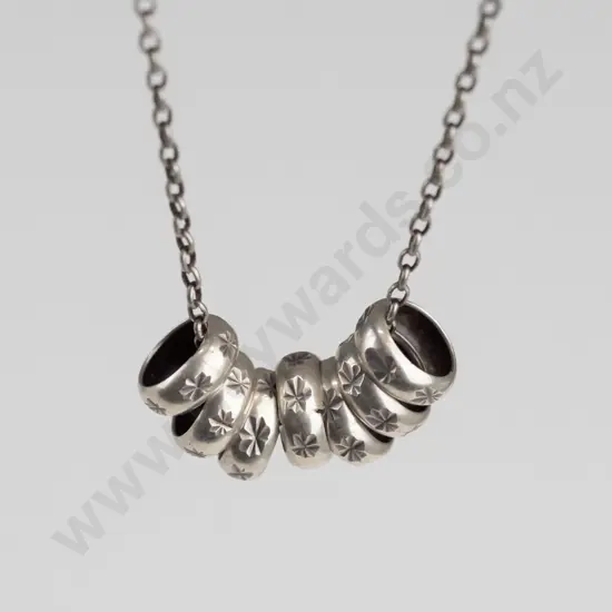 sterling silver necklace with 7 small rings stamped 925