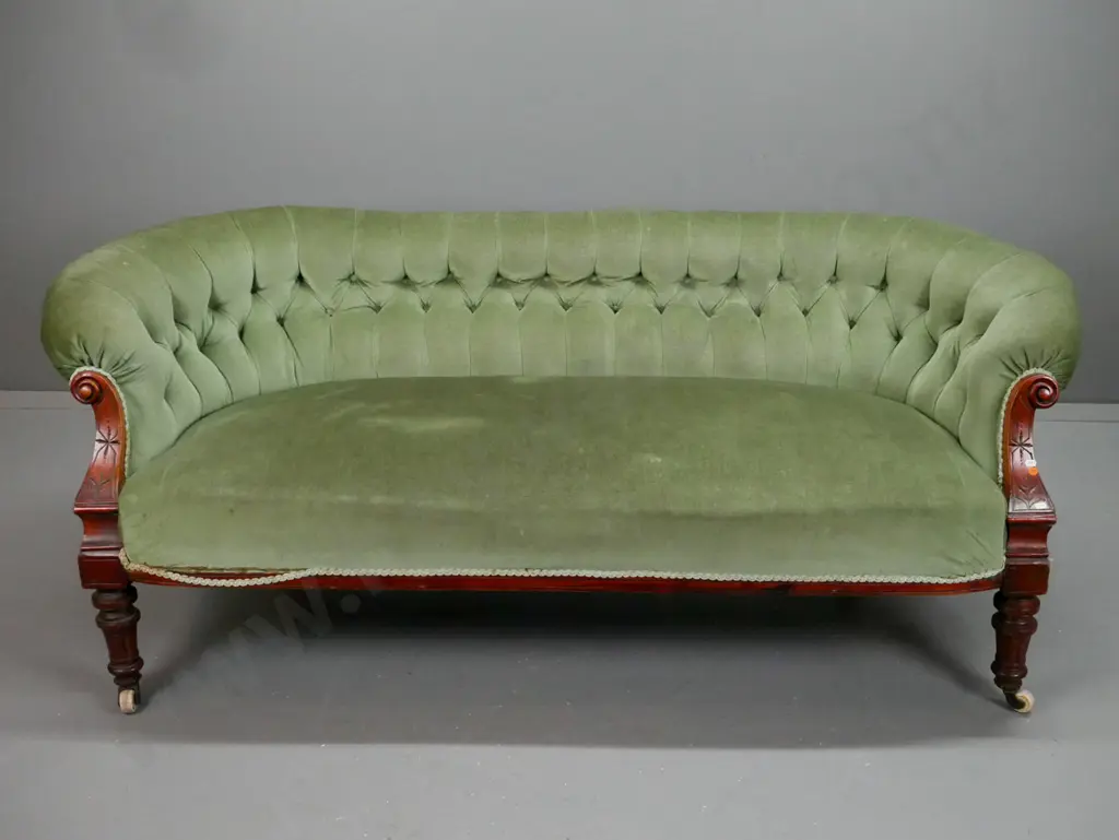 Victorian walnut settee with carved shaped arms, turned fluted legs, deep button back, porcelain & brass Image 1++