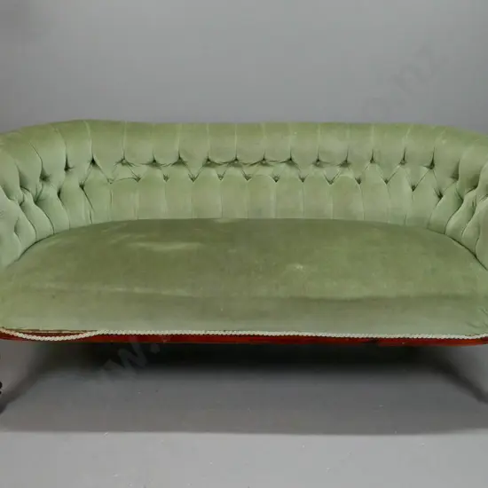 Victorian walnut settee with carved shaped arms, turned fluted legs, deep button back, porcelain & brass