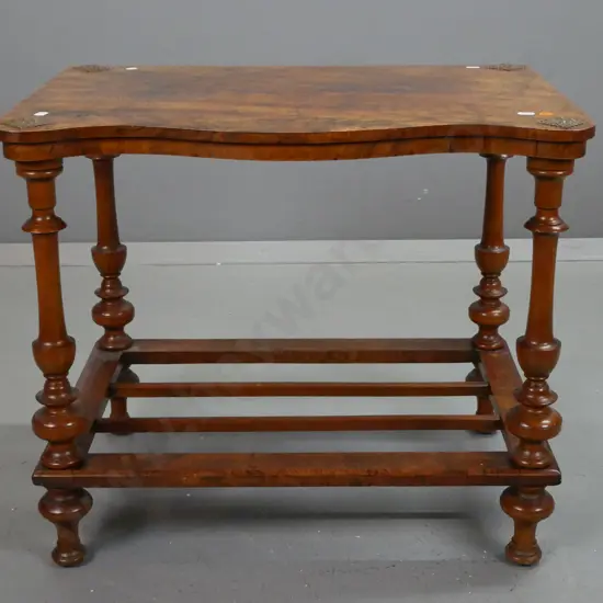 antique burr walnut serpentine shaped top occasional table w/ diamond shaped metal caps on top, turned supports & feet,