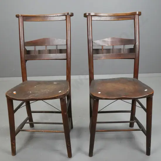 pair of English ecclesiastical elm and beech chairs. Brass makers plaque on back; Charles Farris, London