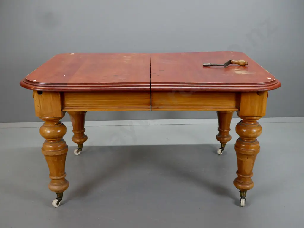 New Zealand colonial rimu turned leg wind out table, on white china cup casters. Has borer in the top Image 1++