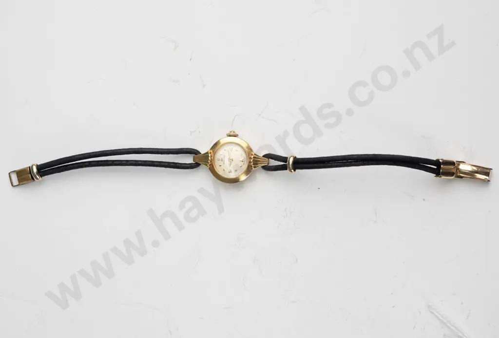 ladies Omega watch,18ct (approx 5gms) case with cordette strap,plated fillings. Watch is in going order Image 1++