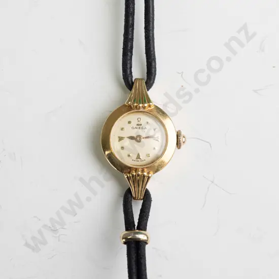 ladies Omega watch,18ct (approx 5gms) case with cordette strap,plated fillings. Watch is in going order