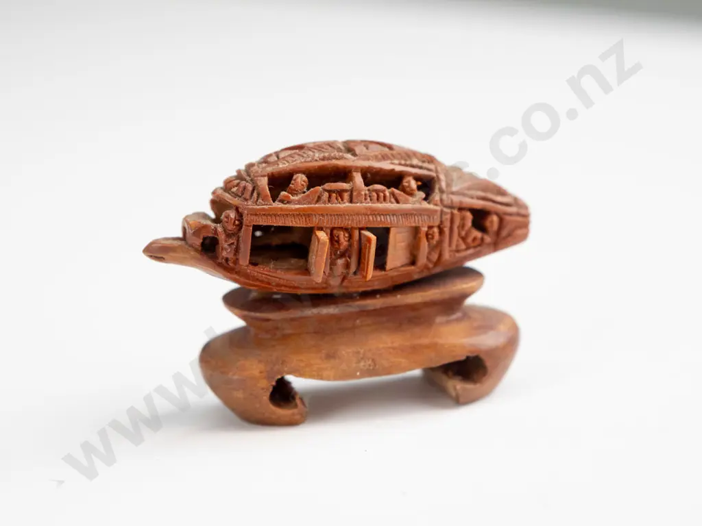 Chinese intricately carved fruit stone or pit, carved into boat shape with movable doors, mounted on wooden stand. Seems Image 1++
