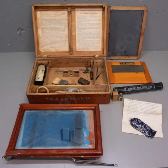vintage Edison Mimeograph in elm case with hinged lid, assorted attachments, parts and ink from an Ellams Duplicator etc
