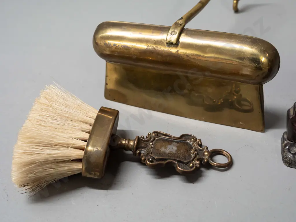 pair of cast metal Scottie dog book-ends with copper lustre finish and a crumb tray with hanging brush, may be missing Image 1++
